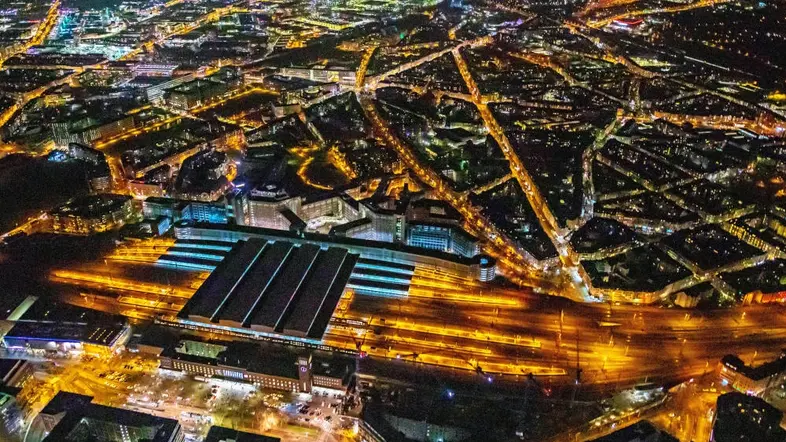 Der beleuchtete Düsseldorfer Hauptbahnhof in der Nacht aufgenommen aus der Luft