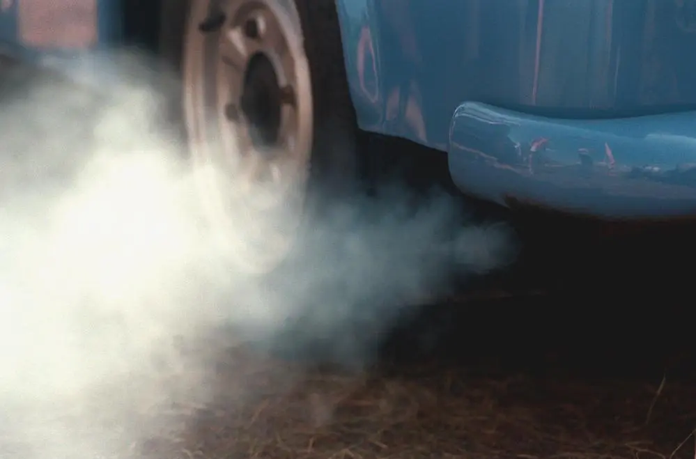 Eine dicke graue Abgaswolke aus einem Auto ohne geregelten Katalysator 