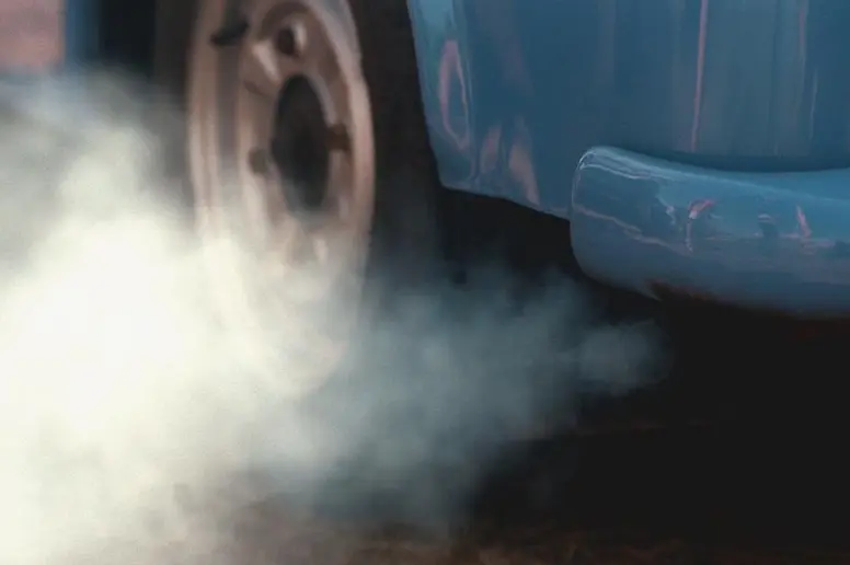 Eine dicke graue Abgaswolke aus einem Auto ohne geregelten Katalysator 