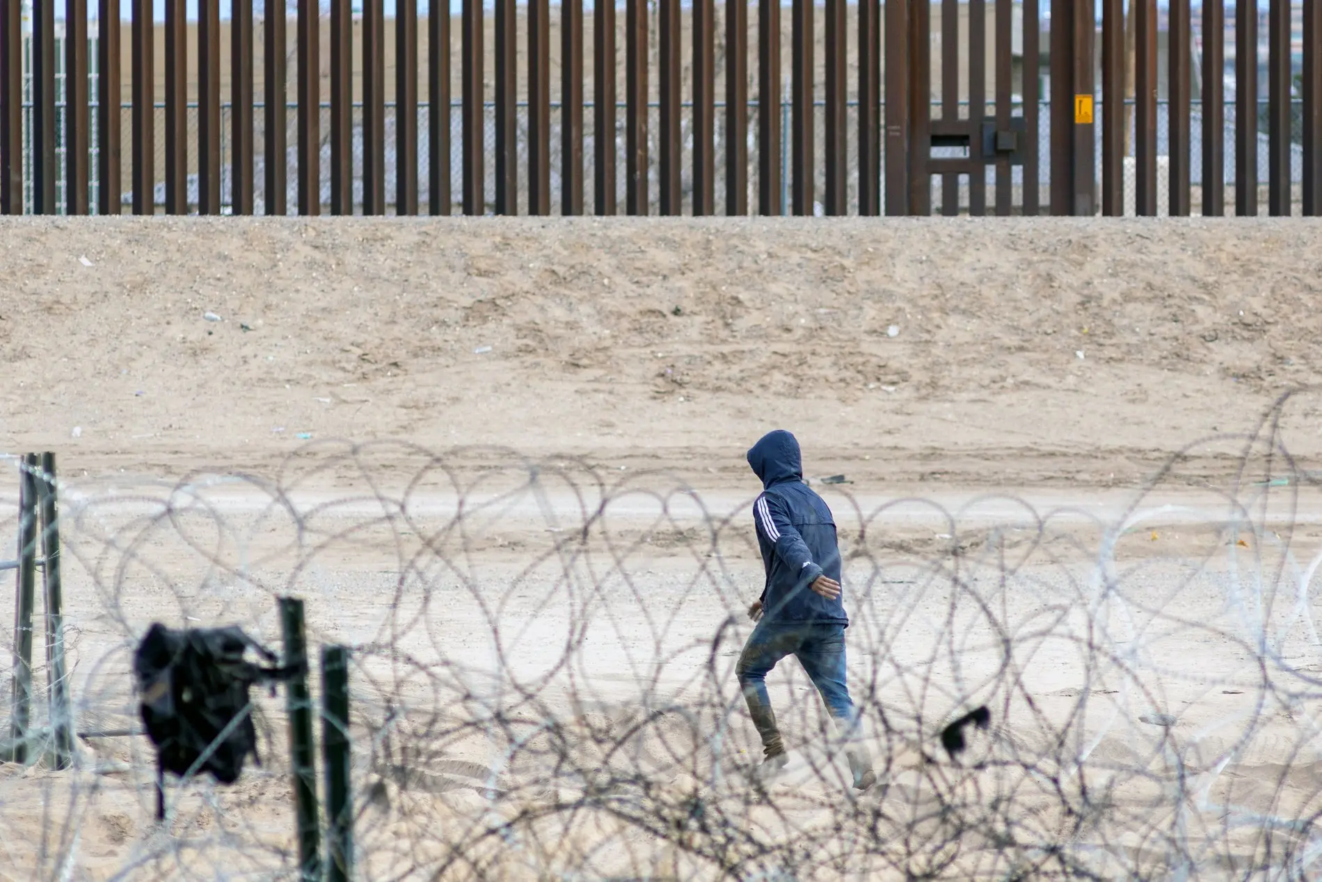 Migrant hinter dem Maschendrahtzaun an der mexikanischen Grenz