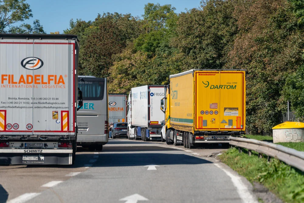 Zahlreiche Lkw und ein Reisebus stehen dicht an dicht auf einem Rastplatz