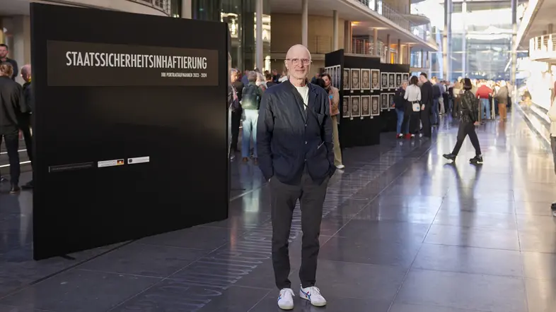 Der Fotograf André Wagenzik vor seiner Ausstellung "Staatssicherheitsinhaftierung" bei der Eröffnung im Paul-Löbe-Haus.