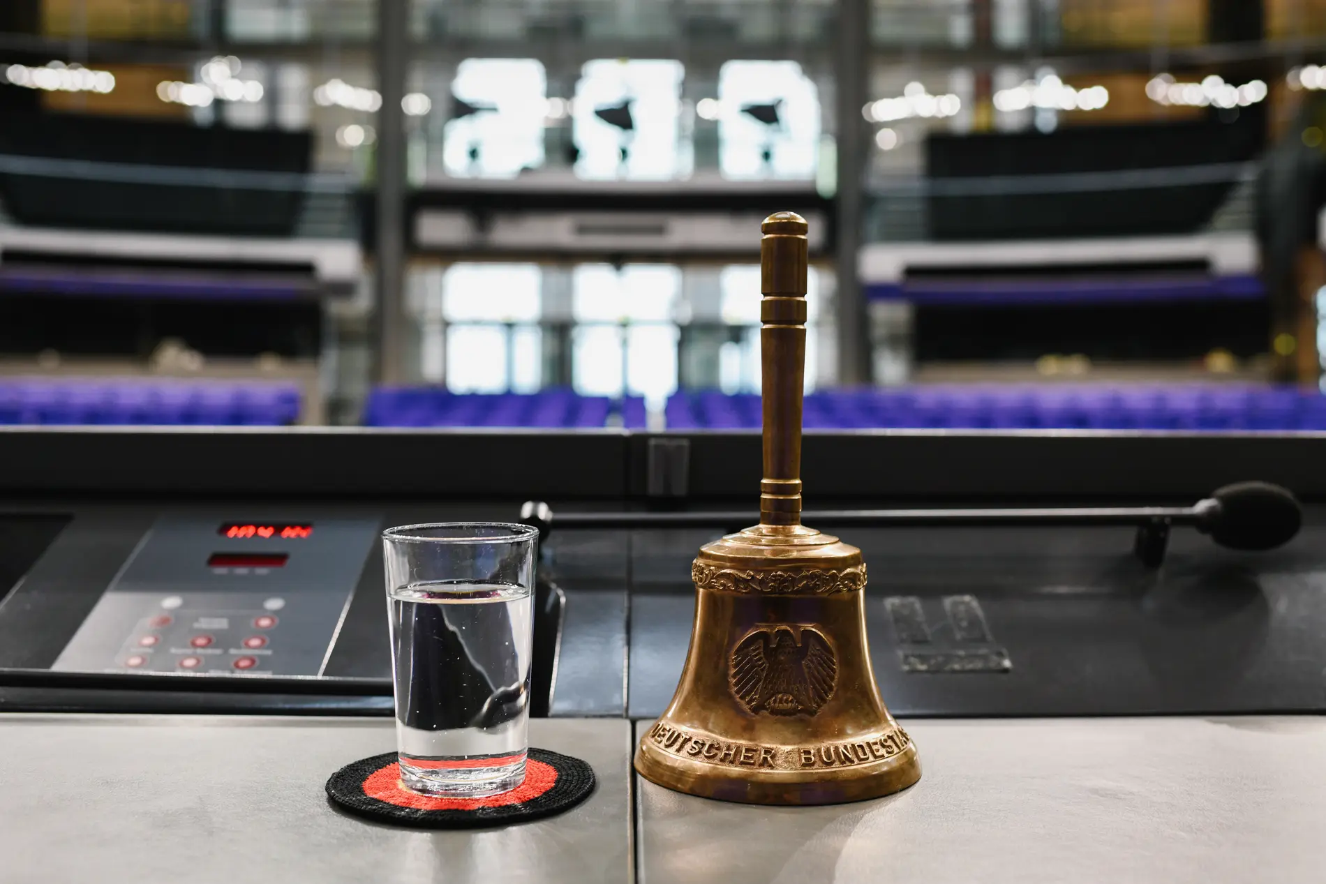 Geschäftsordnung Stuhl des Bundestagspräsidenten mit einem Glass Wasser und der Glocke im Fokus