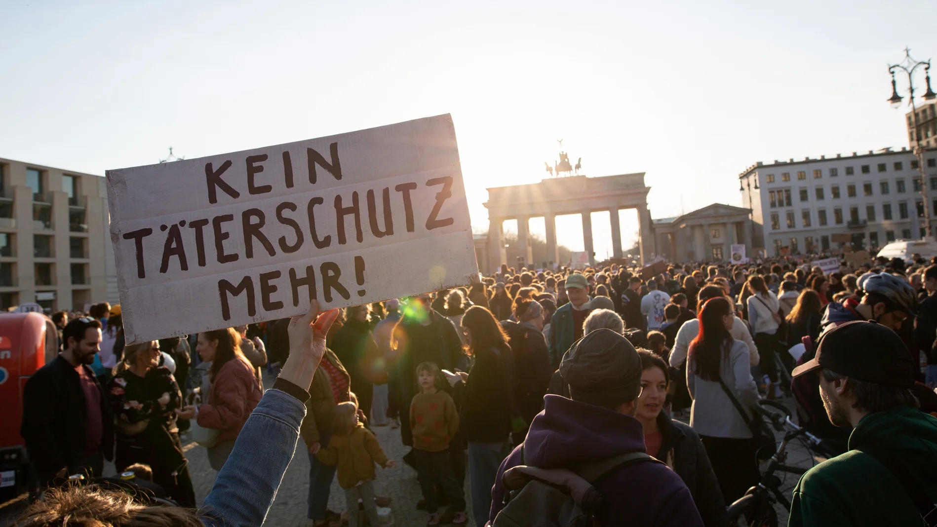 Demonstranten mit Schild "Kein Täterschutz mehr!"