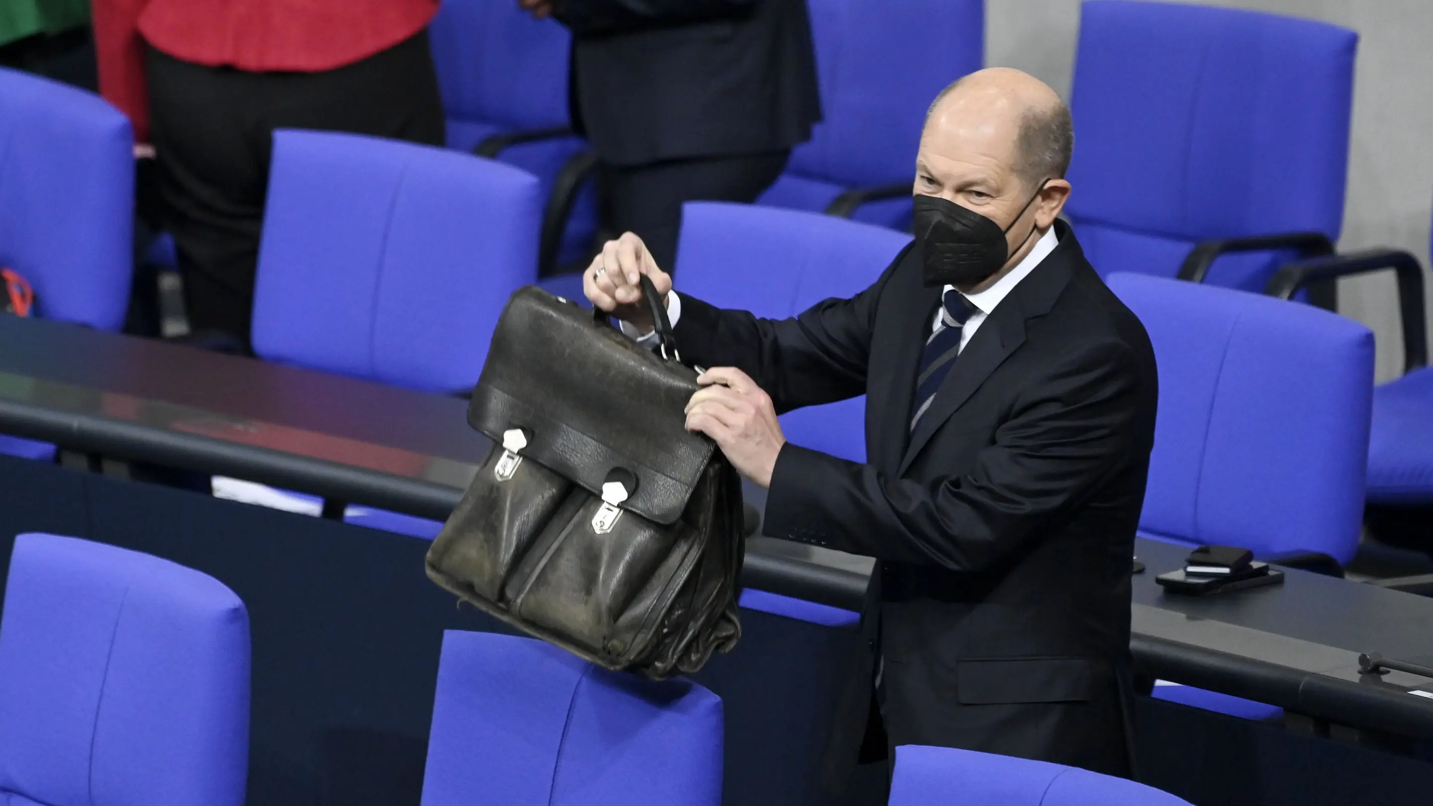 Bundeskanzler Olaf Scholz (SPD) mit Aktentasche im Plenarsaal.