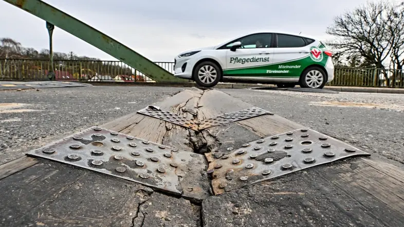 Das Foto zeigt eine kaputte Straße. 