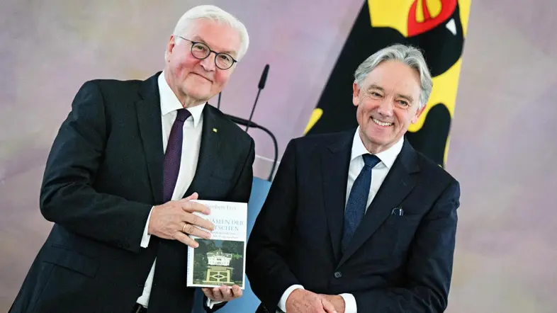 Steinmeier hält Frei's Buch, beide lächeln.