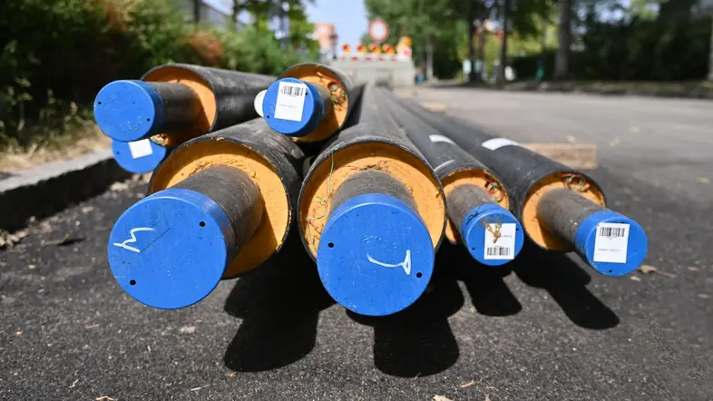 Fernwärmerohre liegen an einem Straßenrand.