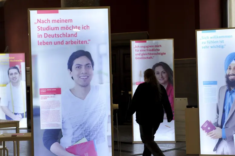 Plakate mit Porträts von Migranten in einer Wanderausstellung an der Universität in Freiburg.